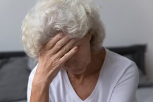 Unhappy sad mature female in nursing home