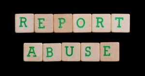 Report Abuse written on wooden blocks