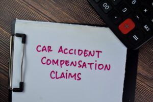  Car Accident Compensation Claims write on paperwork isolated on Wooden Table.