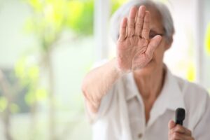 Old lady stop gesture with palm against nursing home abuse